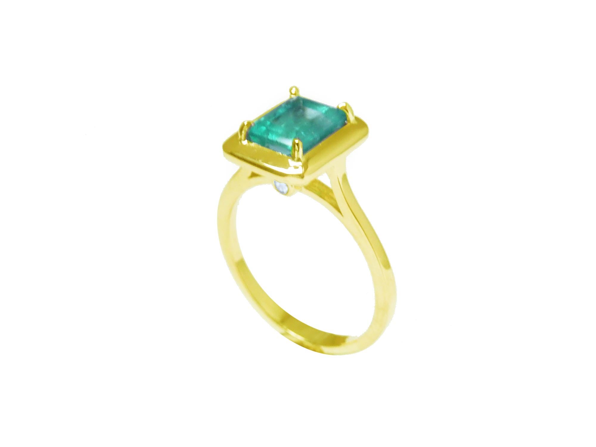 A 14k emerald solitaire ring on a half side position showing the top and side band ring profile.