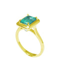 A 14k emerald solitaire ring on a half side position showing the top and side band ring profile.