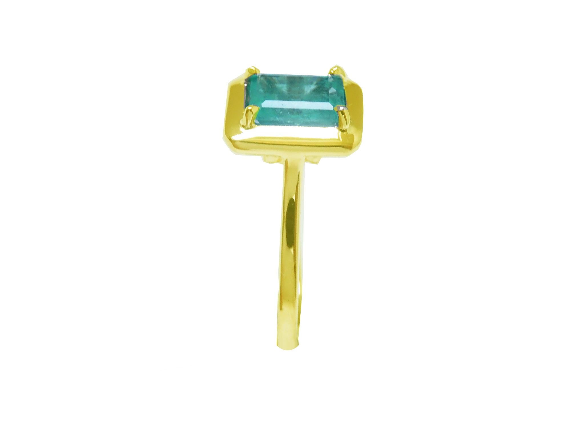 This emerald solitaire ring image shows the side of the gemstone and the band ring profile.