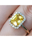 14K yellow gold ring with emerald-cut natural yellow sapphire and diamond halo.