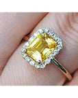 14K yellow gold ring with emerald-cut natural yellow sapphire and diamond halo.