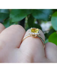 14K yellow gold ring with an emerald-cut natural yellow sapphire and diamond halo.