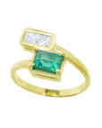 This You and me emerald and diamond engagement ring with a rectangular colombian emerald and two princess-cut natural diamonds was hand-crafted in 18k gold