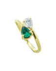 You and Me emerald and diamond ring features a paired pear-cut natural diamond in the classic toi et moi style, handcrafted in 18k yellow gold.