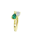 A yellow gold you and me or toi et moi style ring paired a pear-cut natural emerald and diamond.