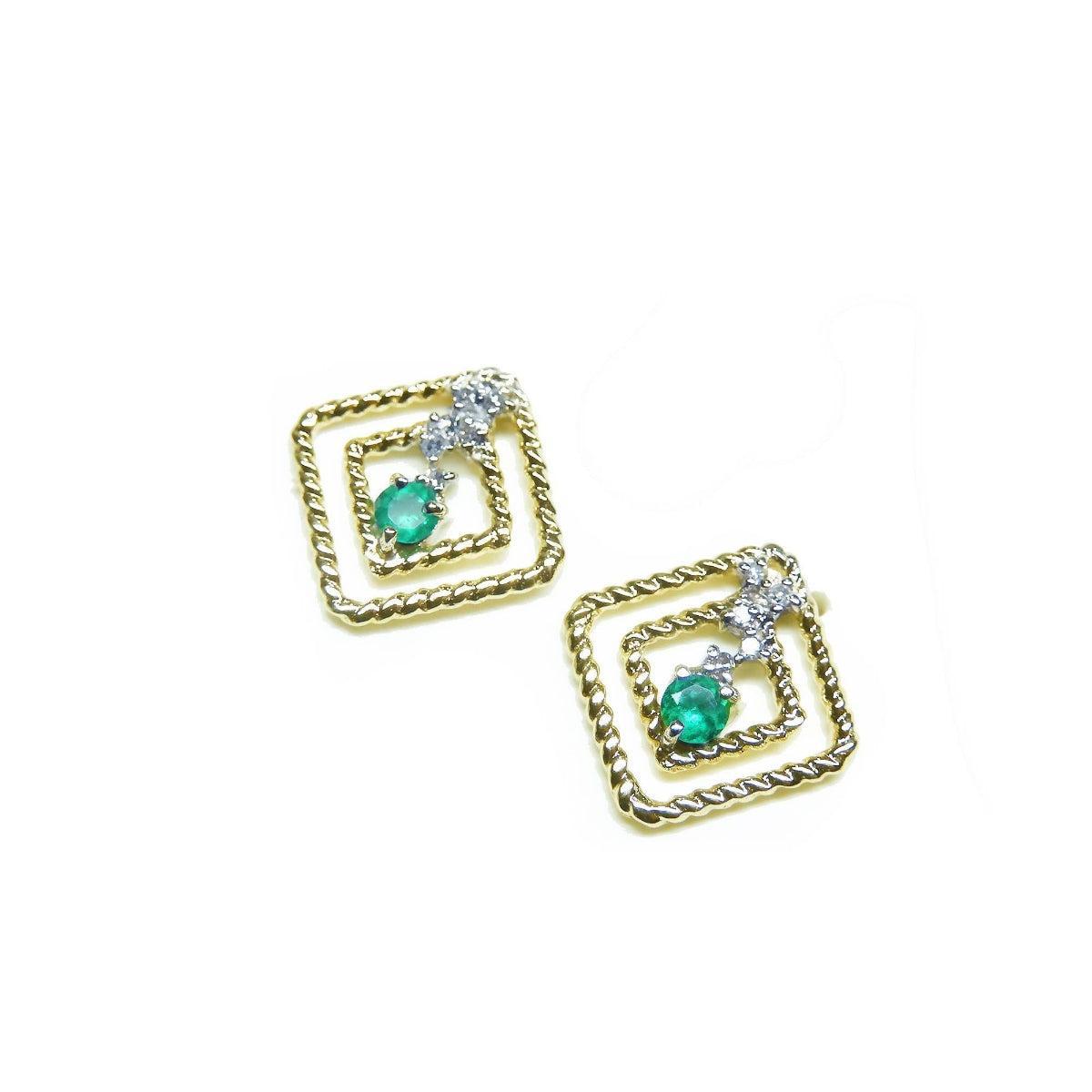 A pair of 14K yellow gold emerald post earrings with round cut Colombian emeralds set in a double frame rope decoration.