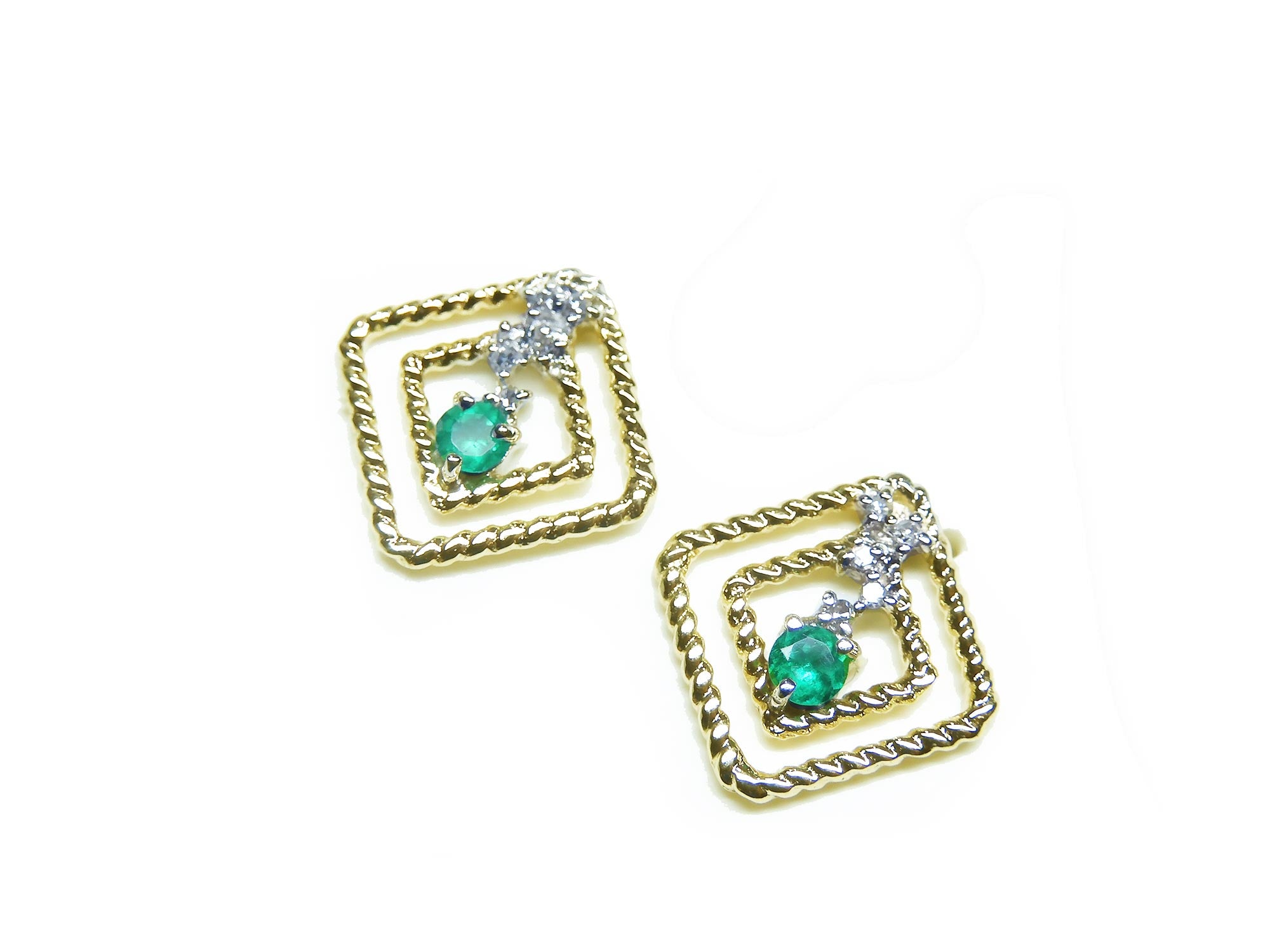 A pair of 14K yellow gold emerald post earrings with round cut Colombian emeralds set in a double frame rope decoration.