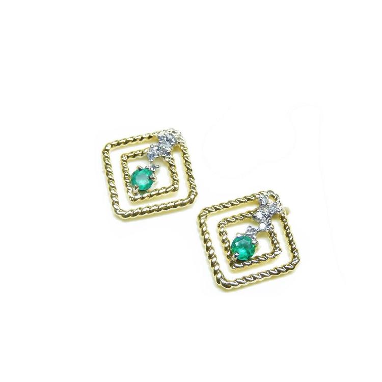 A pair of 14K yellow gold emerald post earrings with round cut Colombian emeralds set in a double frame rope decoration.