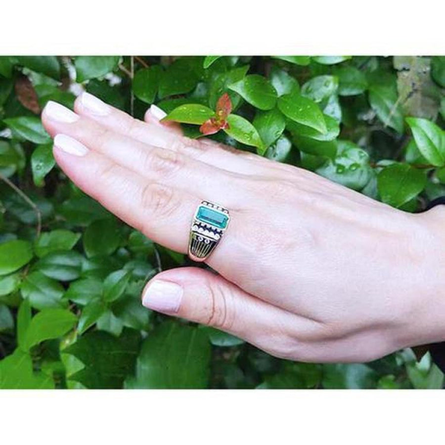 Men's 14K yellow gold ring with a bezel-set Colombian emerald and burnish-set diamonds.