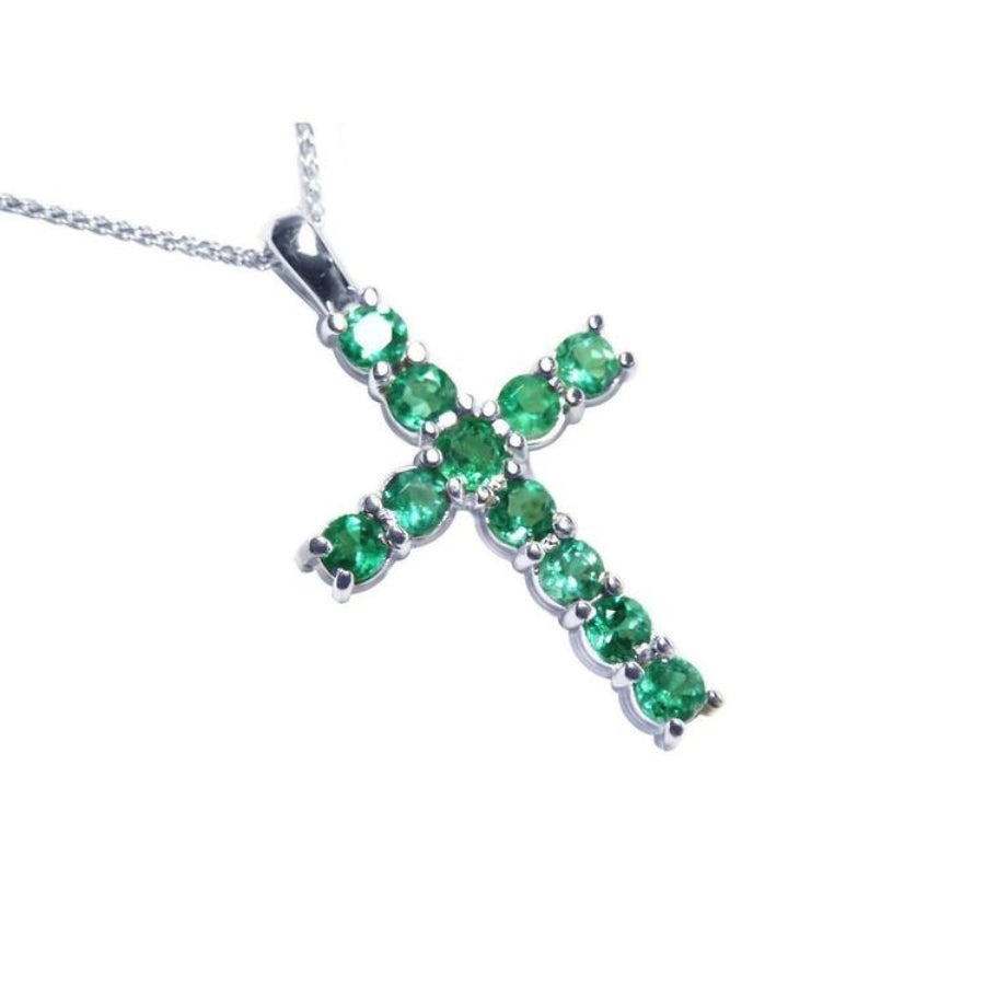 18K white gold cross pendant with eleven round-cut natural Colombian emeralds.