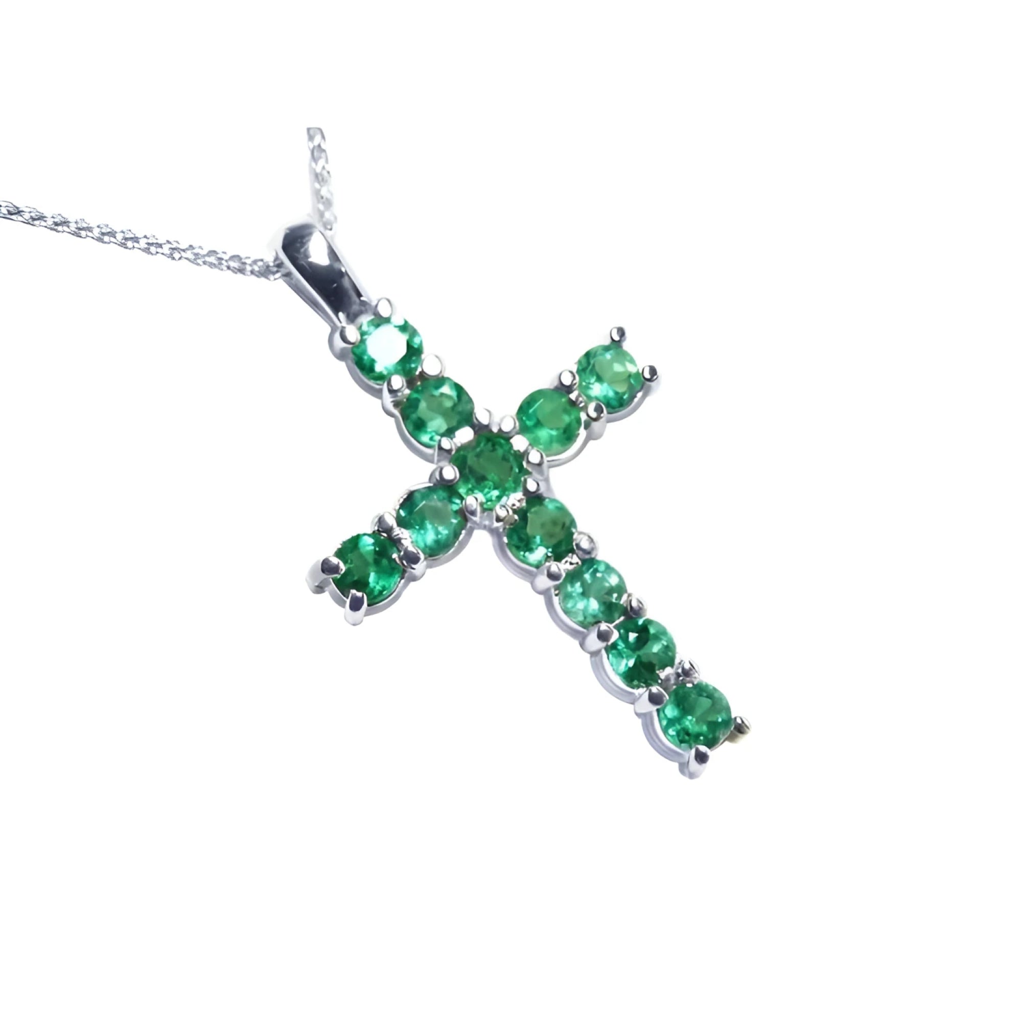 18K white gold cross pendant with eleven round-cut natural Colombian emeralds.