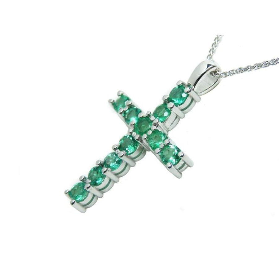 18K white gold cross pendant with eleven round-cut natural Colombian emeralds on a delicate chain.