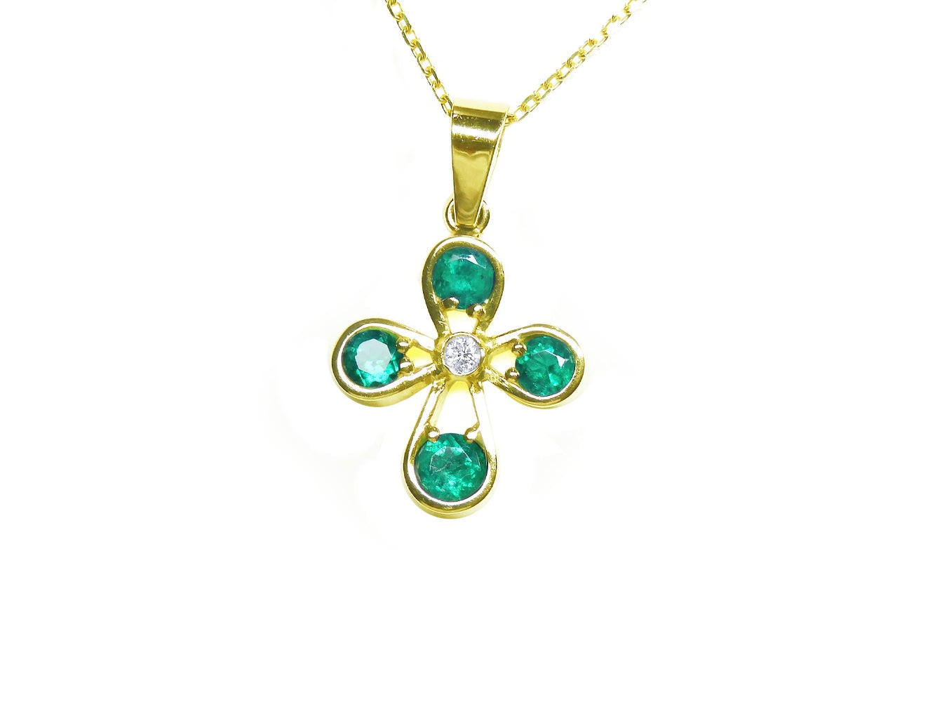 Gold necklace with a natural emeralds pendant on a topside position display.