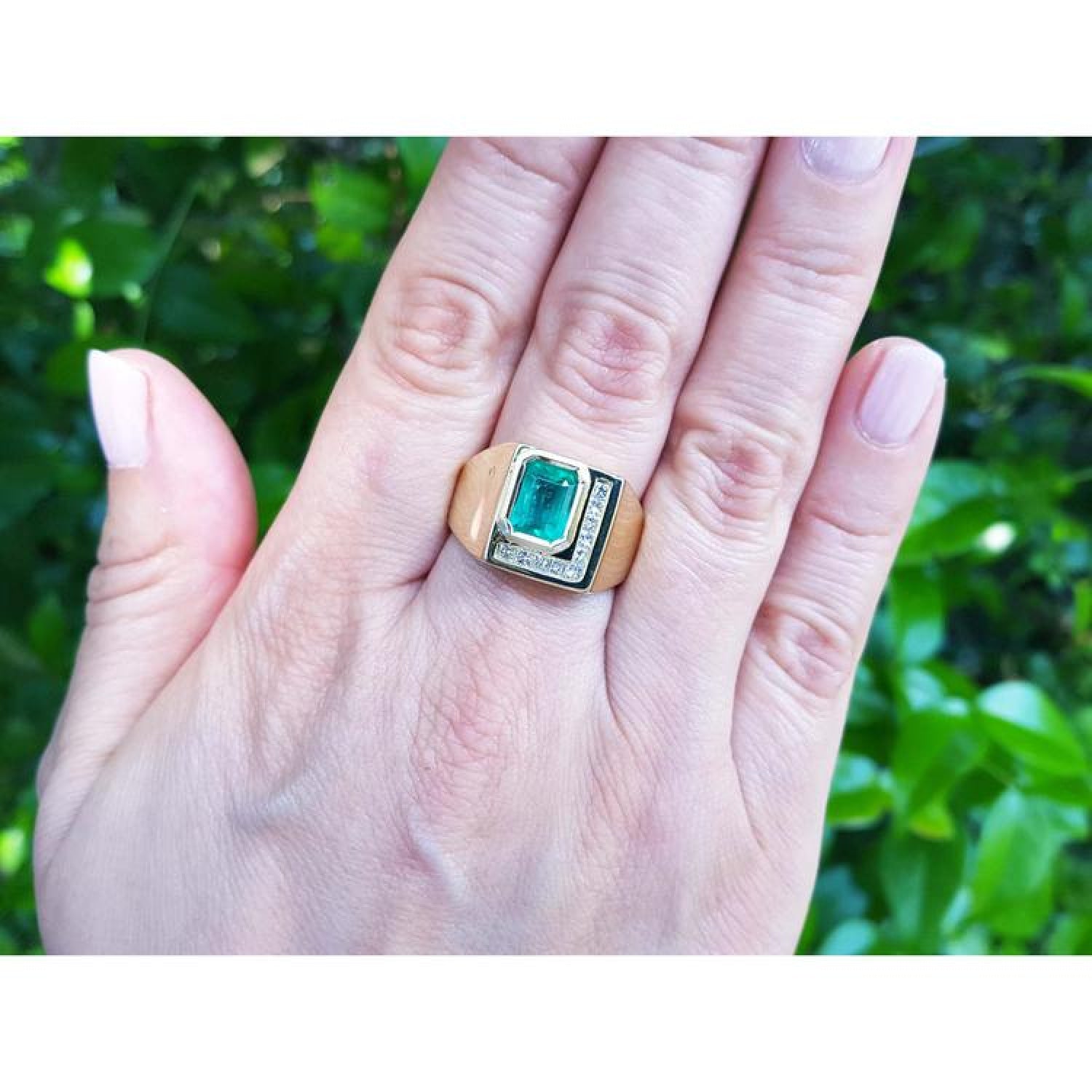 Men's 18K yellow gold ring with a rectangular emerald and channel-set princess-cut diamonds.