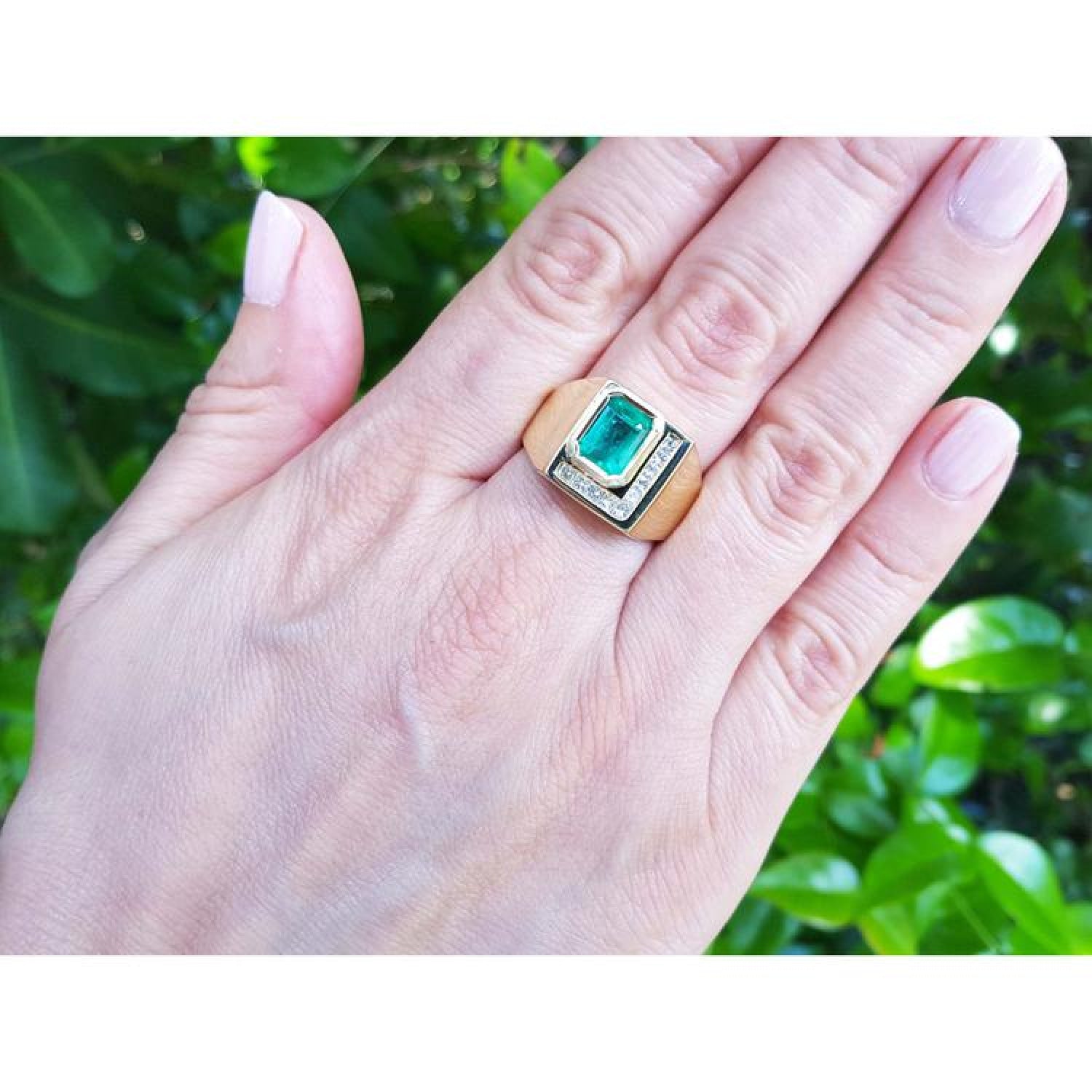 Men's 18K yellow gold ring with a rectangular emerald-cut Colombian emerald and channel-set princess-cut diamonds.