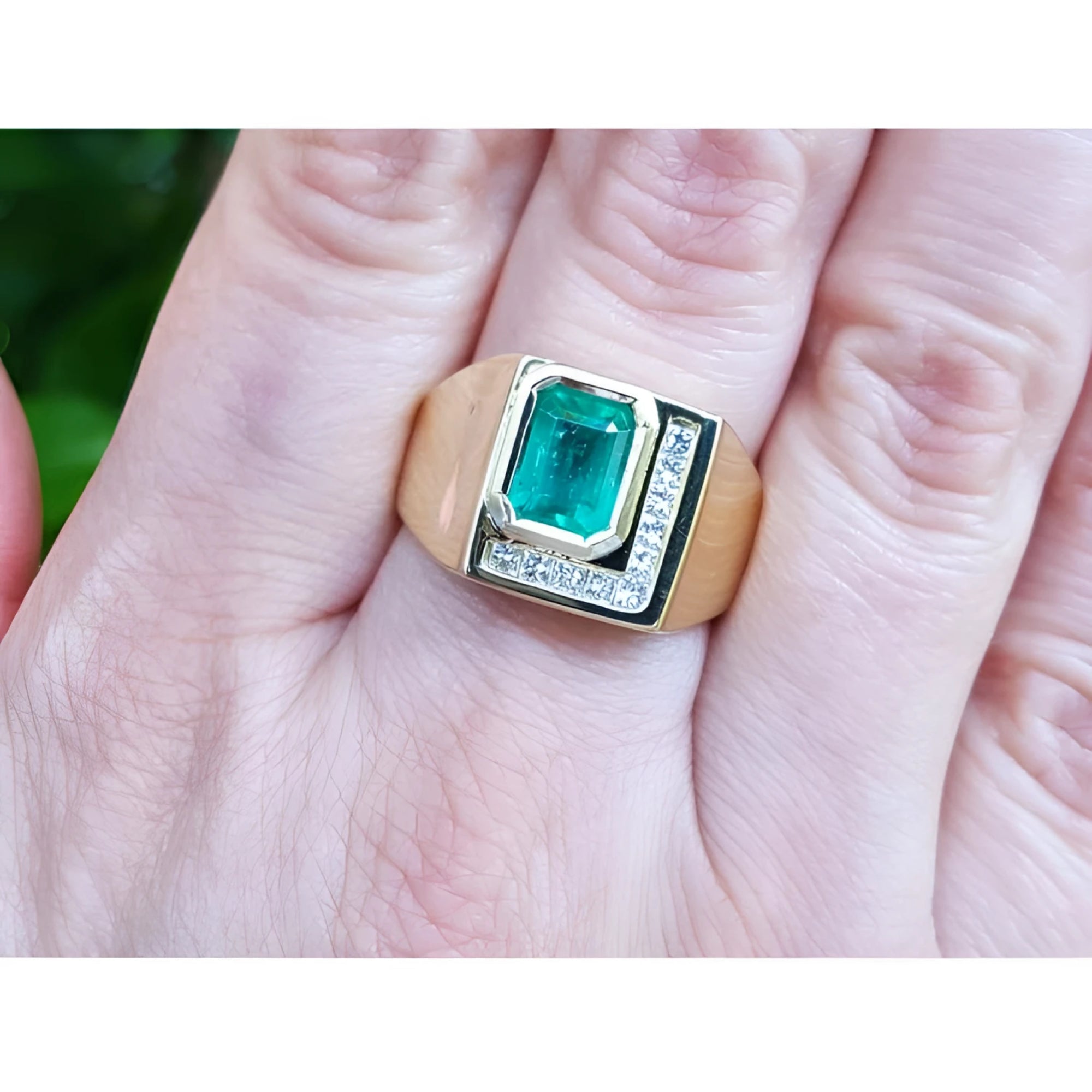 A genuine colombian emerald bezel set and natural princess cut natural diamonds in a 18k yellow gold ring for men.