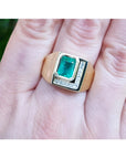 A genuine colombian emerald bezel set and natural princess cut natural diamonds in a 18k yellow gold ring for men.