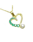 18K yellow gold heart pendant with natural emeralds and a diamond on a delicate chain.