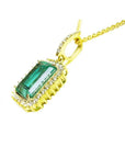 8.04 ct. emerald-cut emerald pendant with halo diamonds in 18K gold, featuring a medium dark green Colombian emerald.