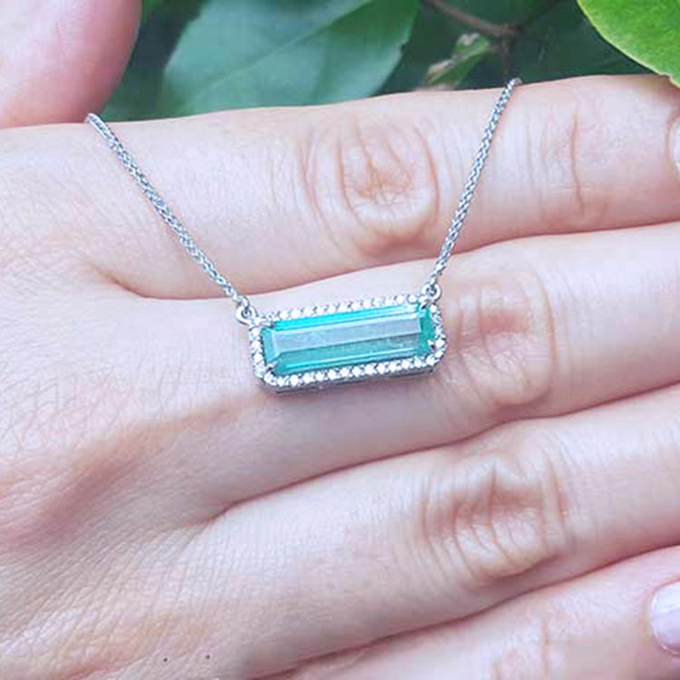 Halo diamond Emerald necklace elongated natural Colombian emerald 3.48 carats east west orientation in 18k white gold