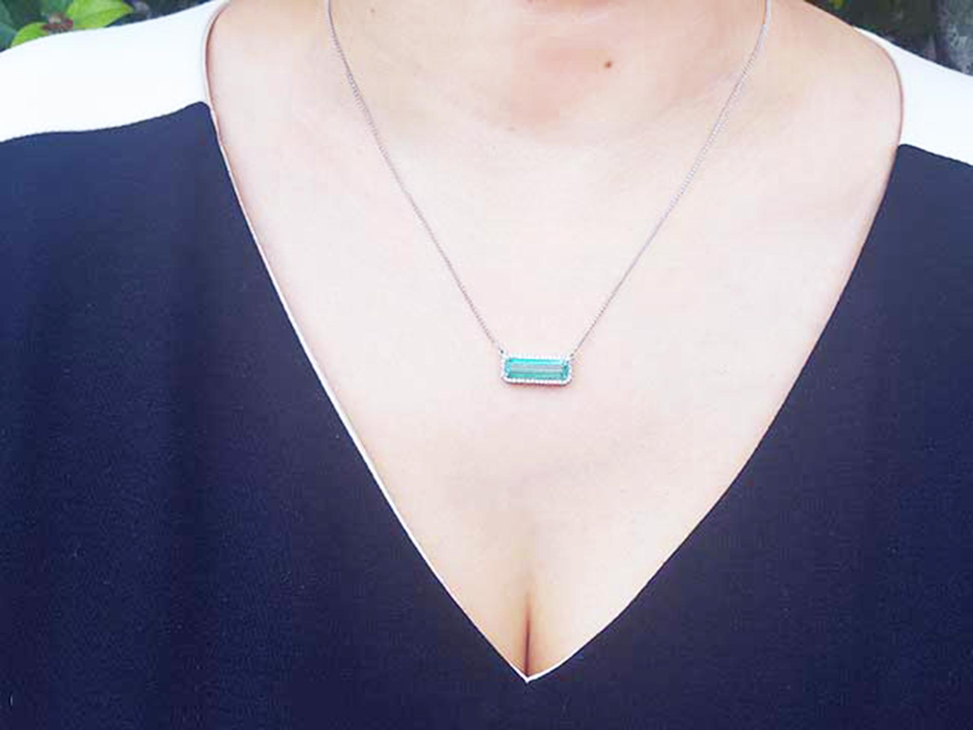 Muzo mine Emerald necklace 3.48 carats east west orientation encircle by halo diamonds crafted in 18k white gold
