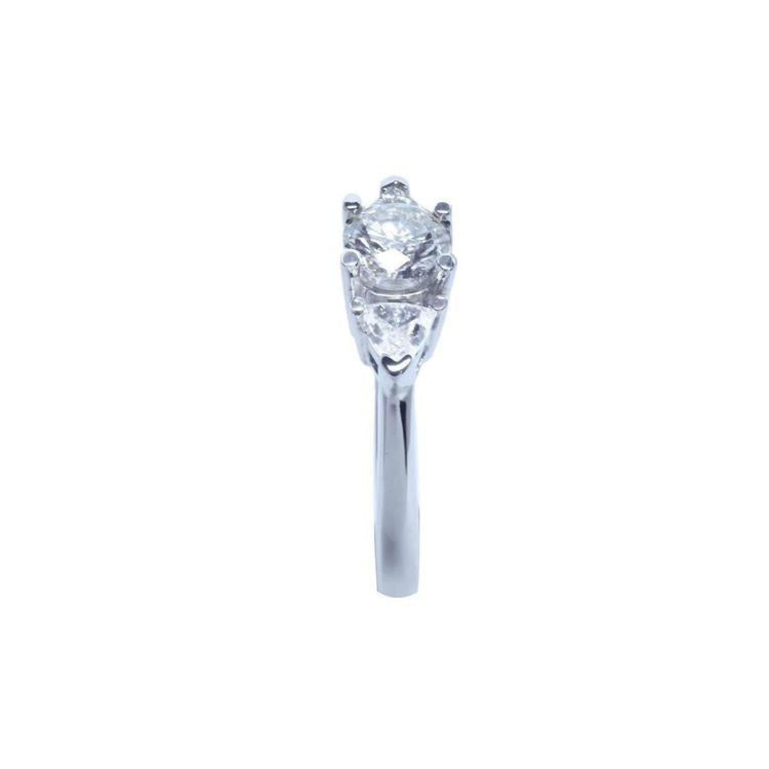 14K white gold engagement ring with a round center diamond and two trillion side diamonds.