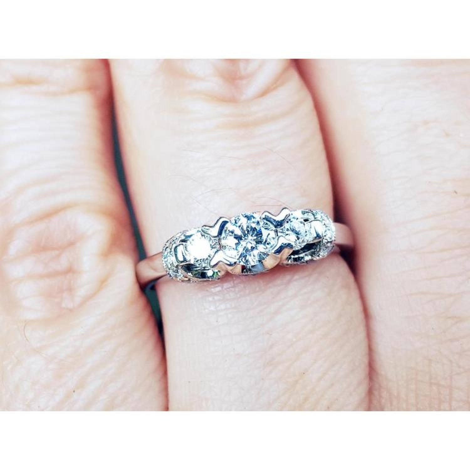 Round cut diamond engagement ring three stone crafted in 14k white gold.