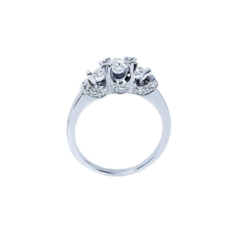 Round cut three stone diamond engagement ring in 14K white gold with pave set accent diamonds.
