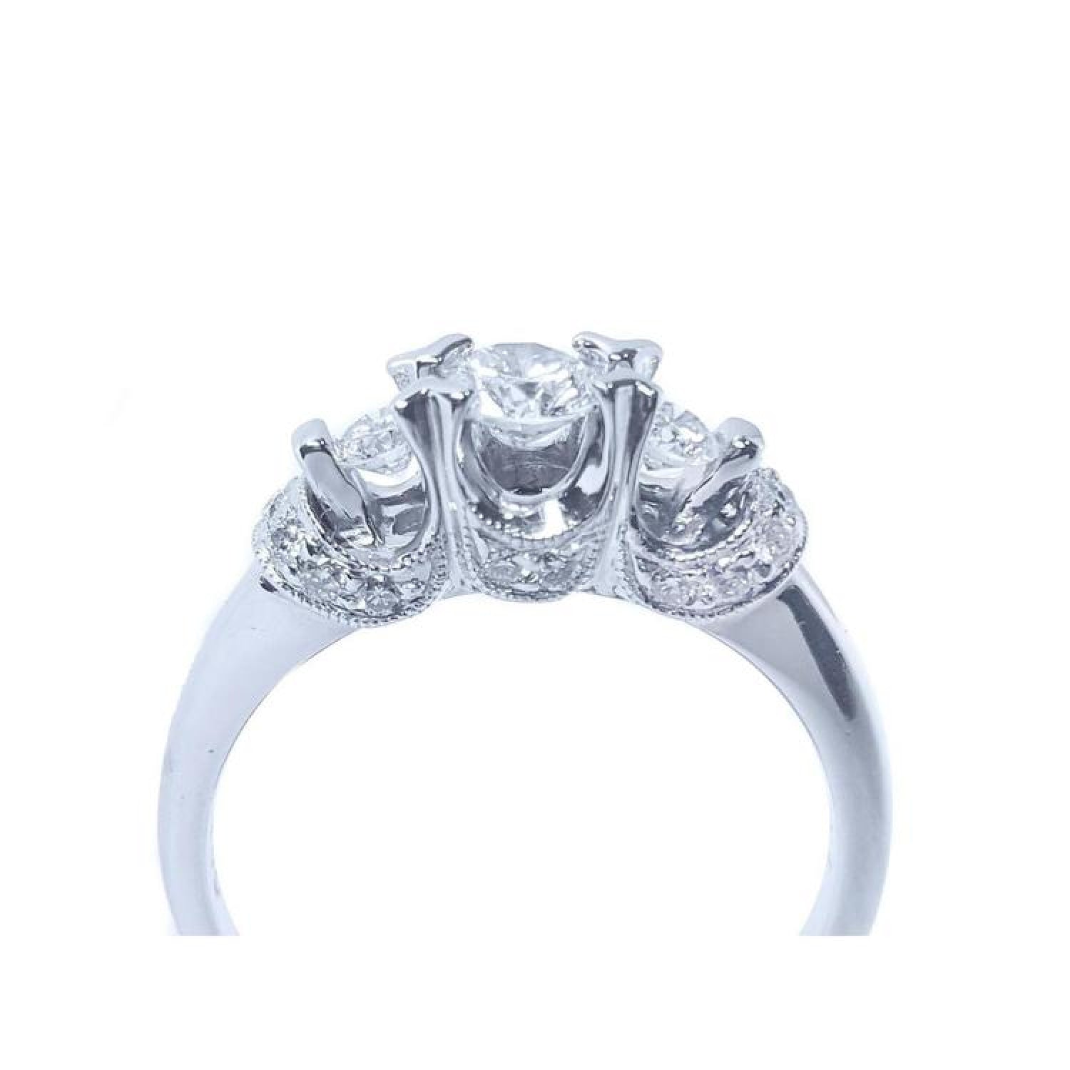 14K white gold three-stone round cut diamond engagement ring with pave accent diamonds.