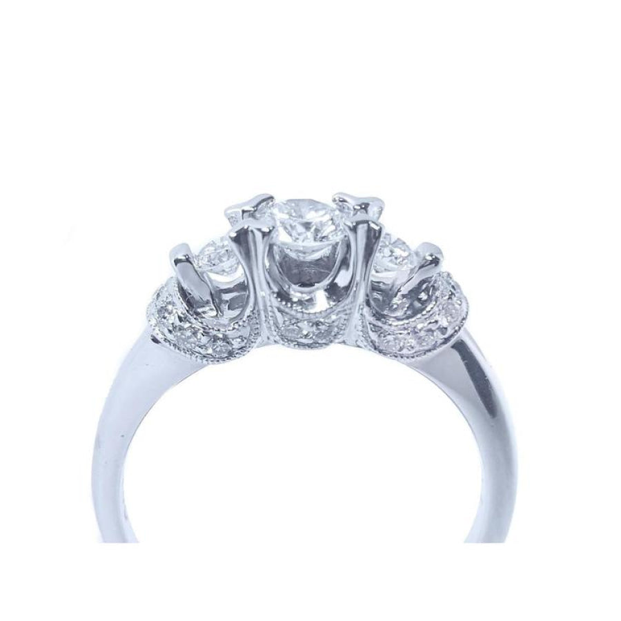 14K white gold three-stone round cut diamond engagement ring with pave accent diamonds.