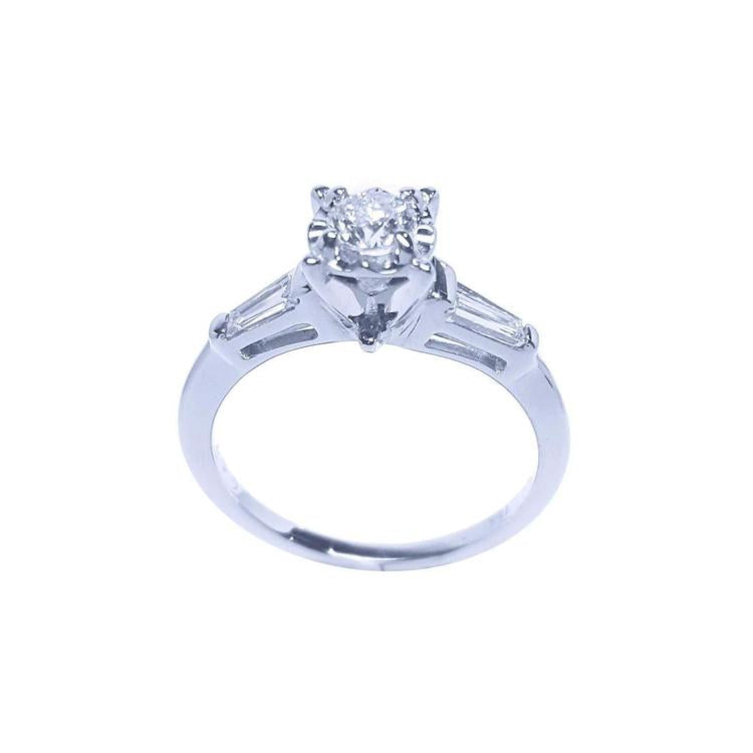 14k white gold engagement ring with a round central diamond and two baguette side diamonds.