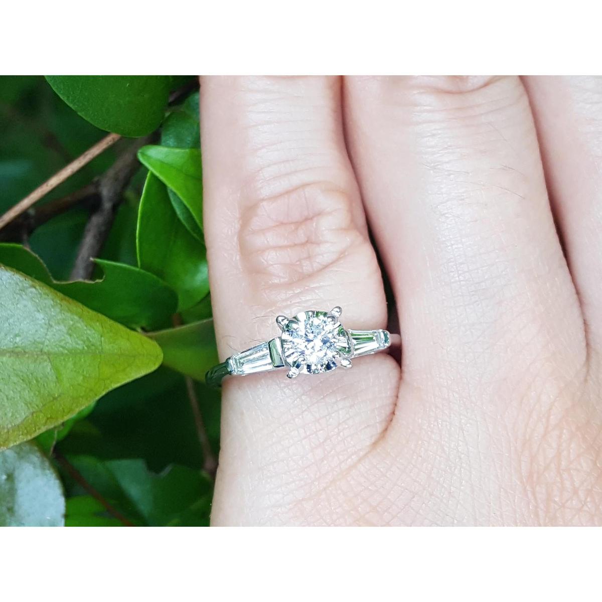 Round cut diamond three stone ring side tapper baguette