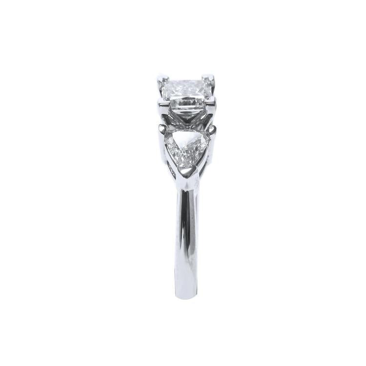 14K white gold ring with a princess cut diamond flanked by two trillion side diamonds.