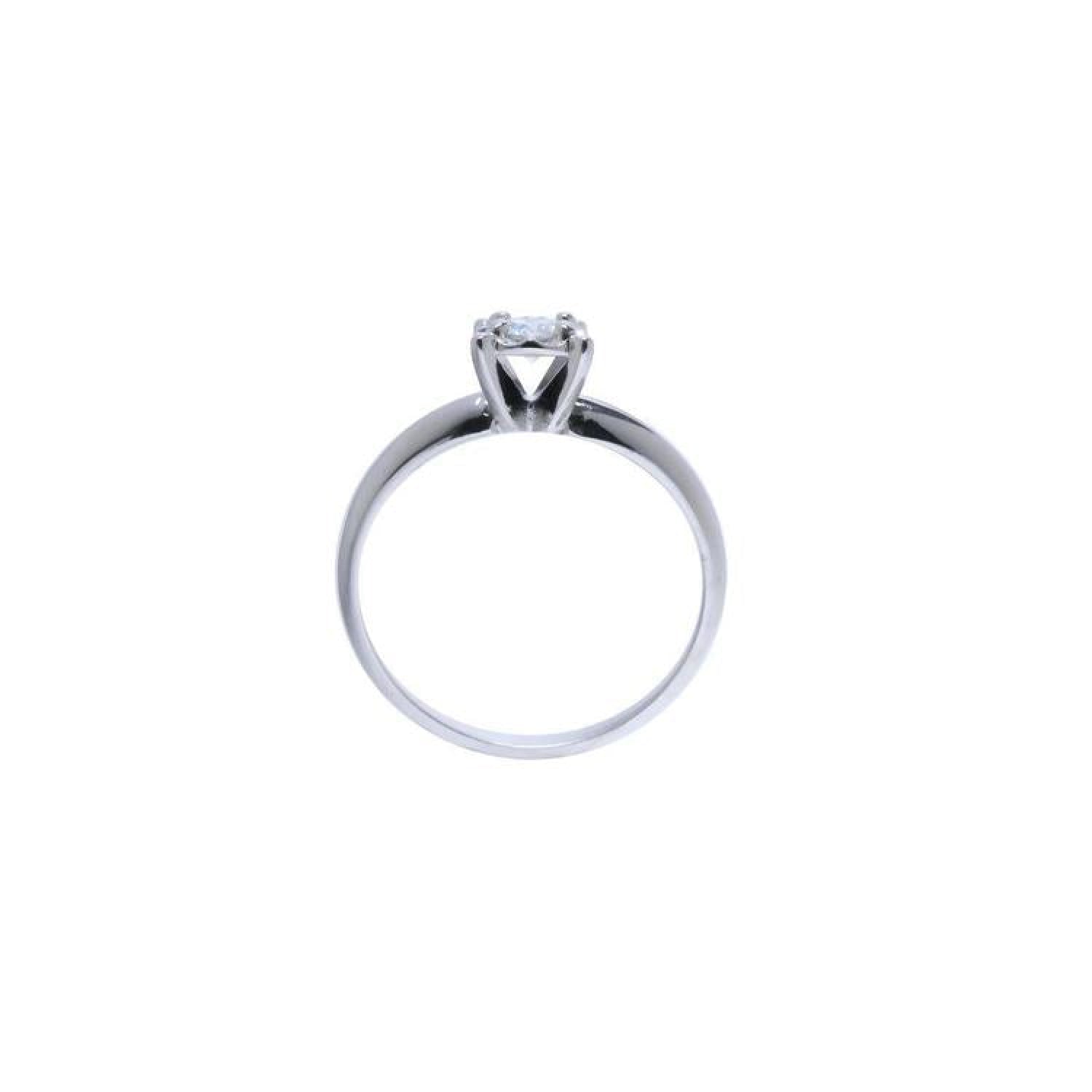 Round cut diamond solitaire engagement ring in 14K white gold with an illusion setting.
