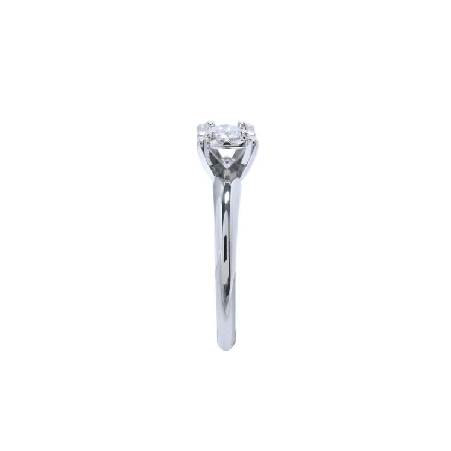Round cut diamond solitaire engagement ring in 14K white gold with an illusion setting.