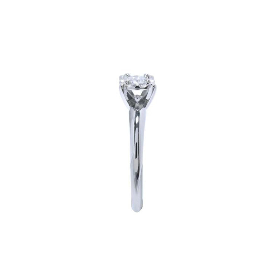 Round cut diamond solitaire engagement ring in 14K white gold with an illusion setting.