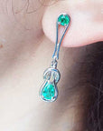 Dangle love knot emerald earrings