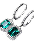 Halo emerald dangle earrings