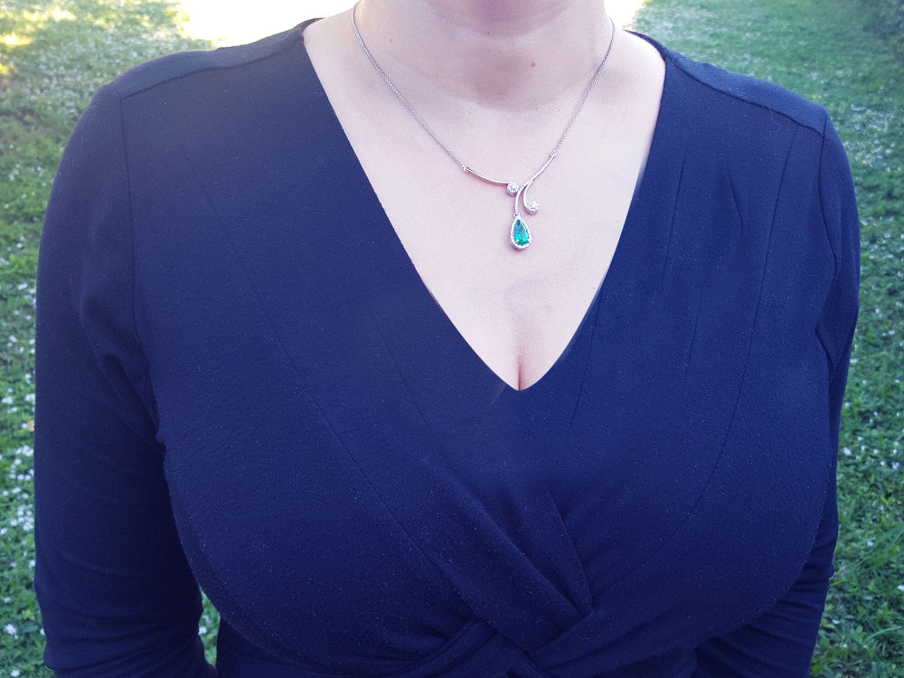 women&#39;s Colombian emerald necklace from the Muzo mines in Colombia, encircled in a halo of natural diamond set in 18k white gold