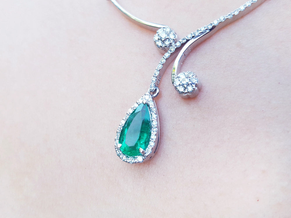 Women's natural emerald necklace: this is a natural emerald, encircled in a halo of natural diamond set in 18k white gold