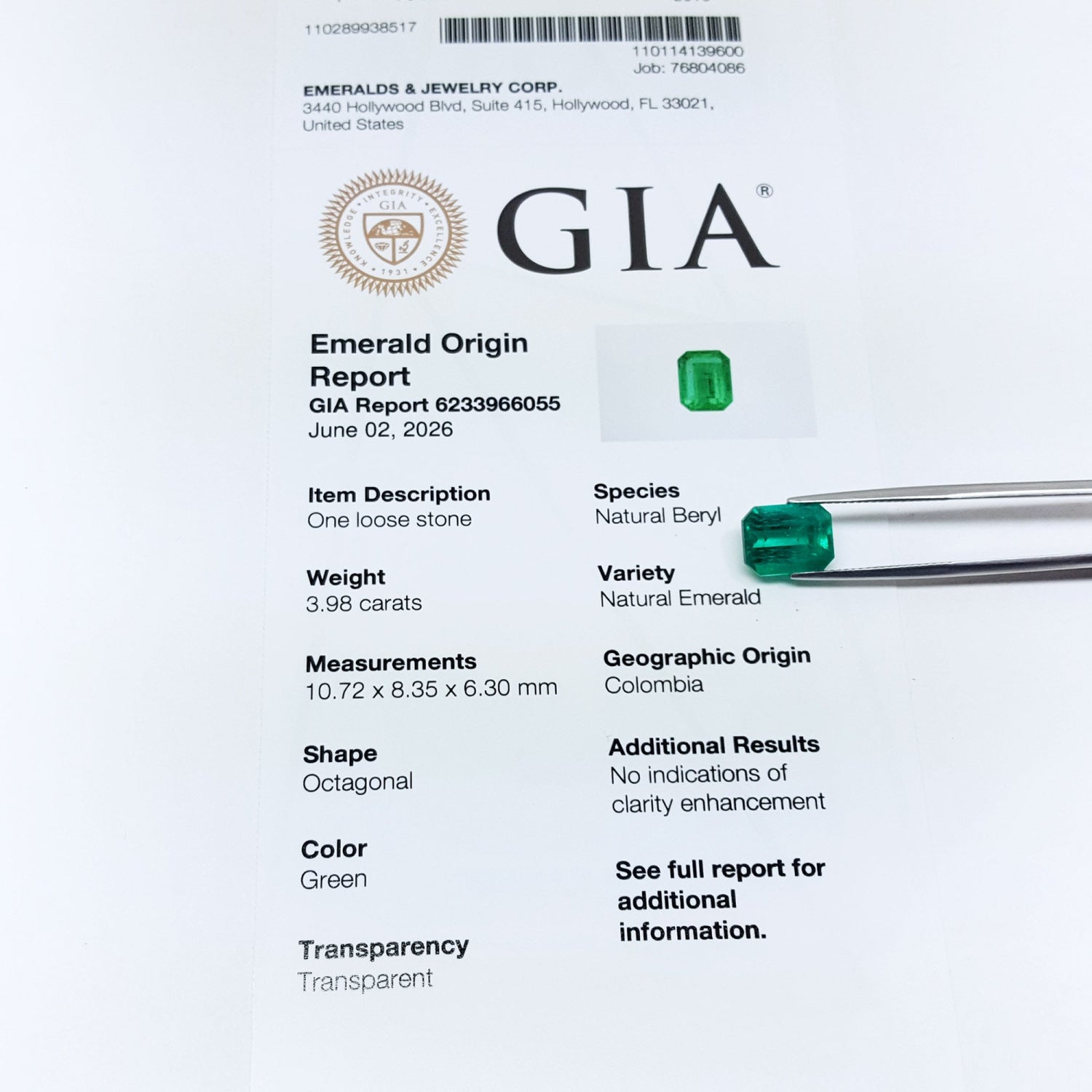 Untreated GIA emerald origin report with green emerald stones on a white background.