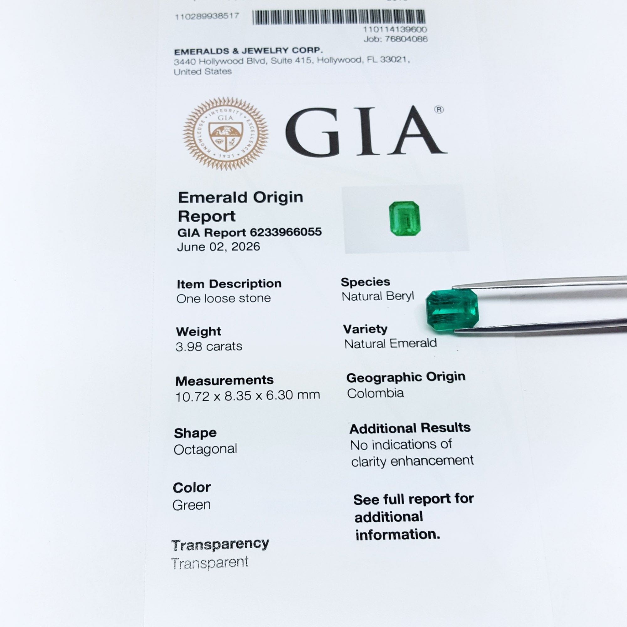 Untreated GIA emerald origin report with green emerald stones on a white background.