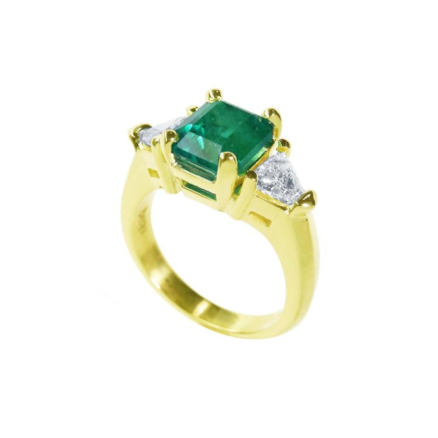 18K yellow gold ring with a GIA certified emerald and side trillion diamonds.