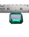 GIA certified 3.55 ct. emerald-cut Colombian emerald gemstone, measured against a ruler.