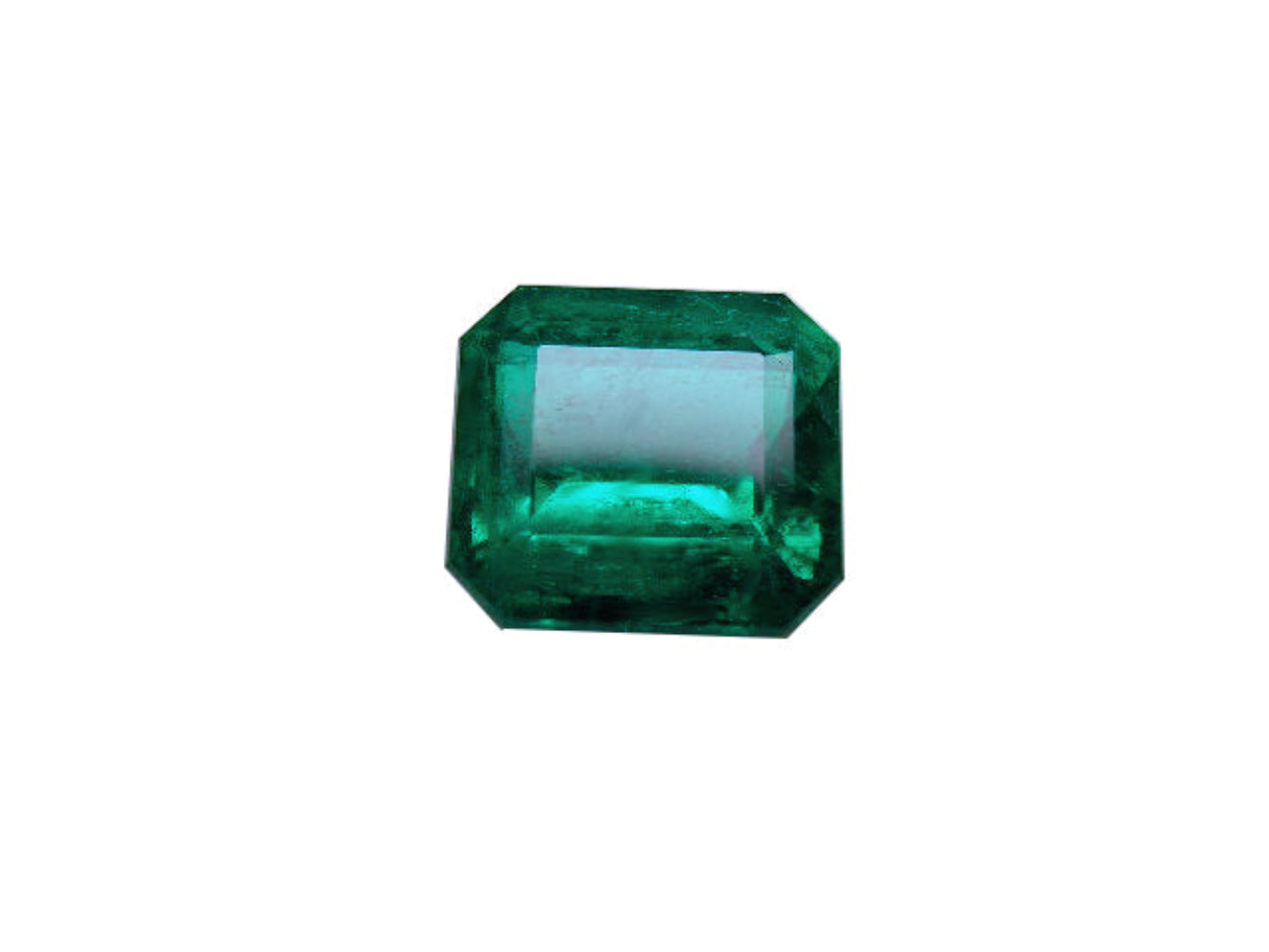 Faceted loose emerald gemstone on a white background