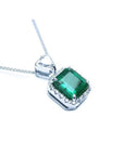GIA-certified 3.55 ct. Colombian emerald pendant in 18K white gold with diamond halo.