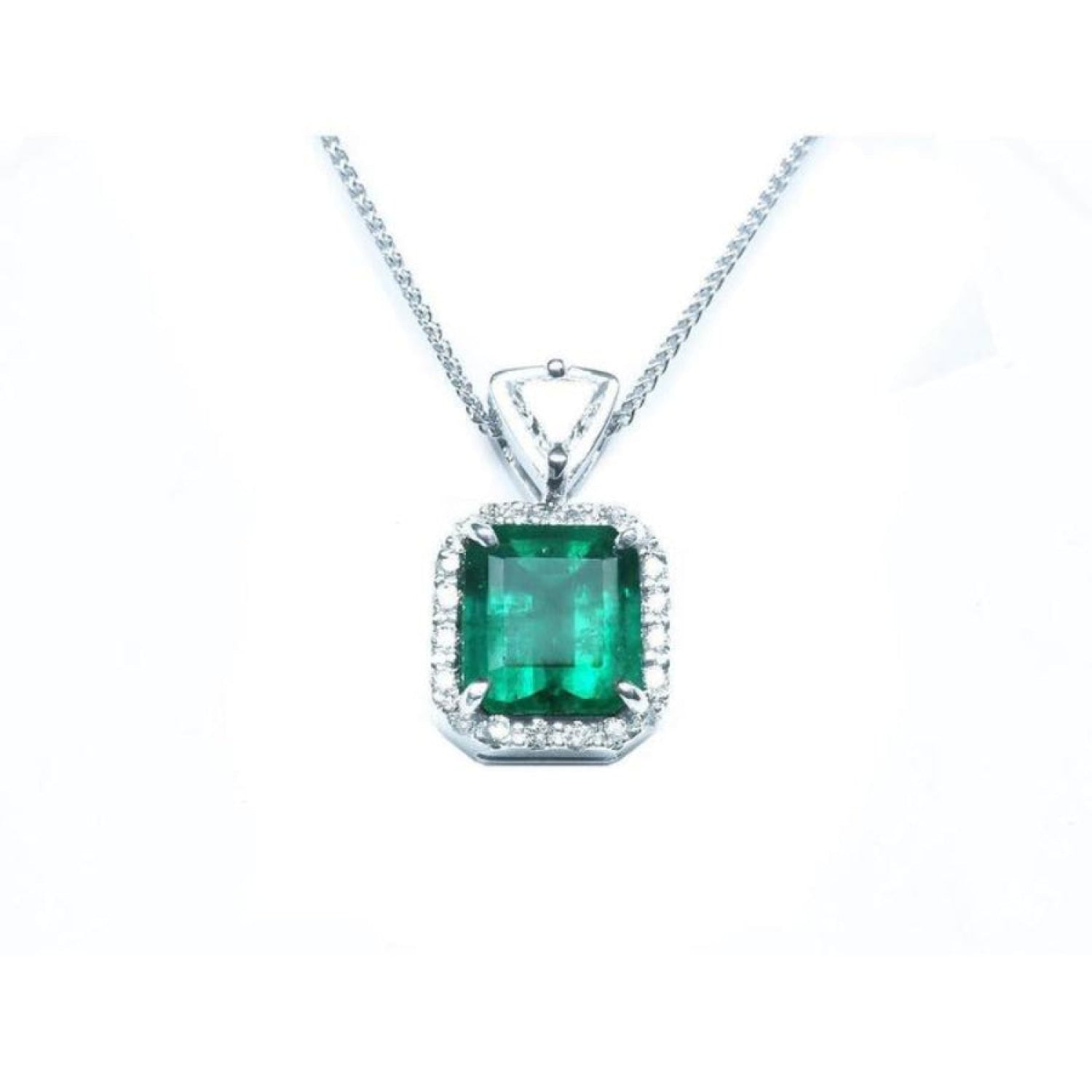 GIA certified Colombian emerald pendant with diamond halo in 18K white gold.
