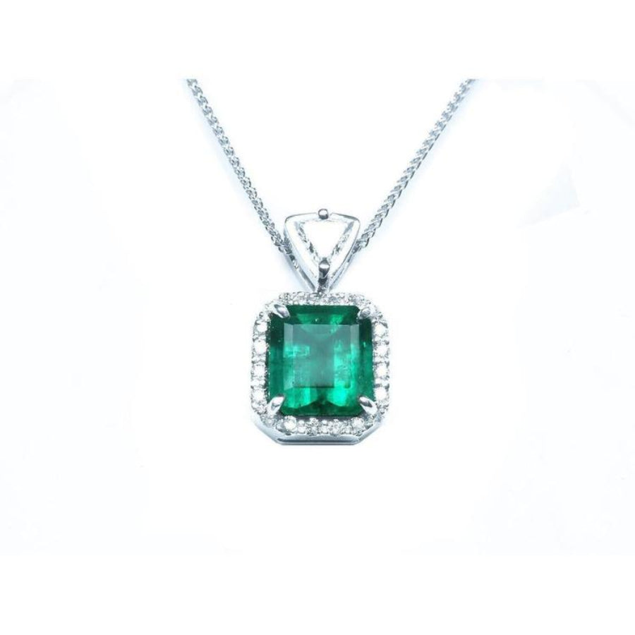 GIA certified Colombian emerald pendant with diamond halo in 18K white gold.