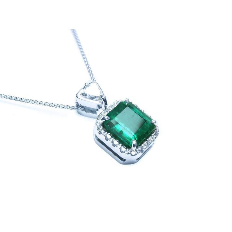 Top and gallery profile view of a natural emerald pendant in 18k white gold.