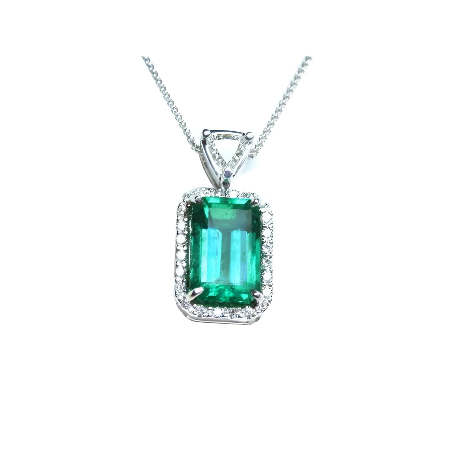 The topside of this certified natural emerald pendant shows the top bail slider with a trillion-cut diamond and the emerald with a halo diamond.